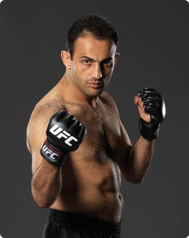 Promotional fight portrait of Roman Mitichyan wearing UFC gloves
